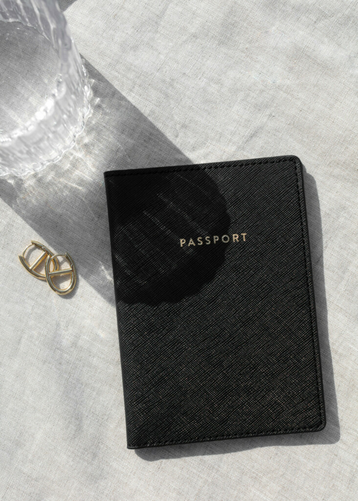 passport set next to set of earrings, ready for a ROOF vacation