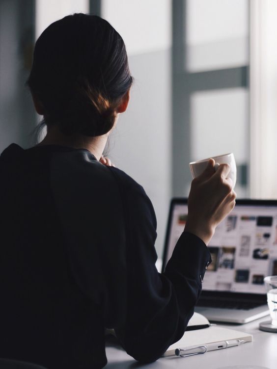Woman holding coffee doing job search
